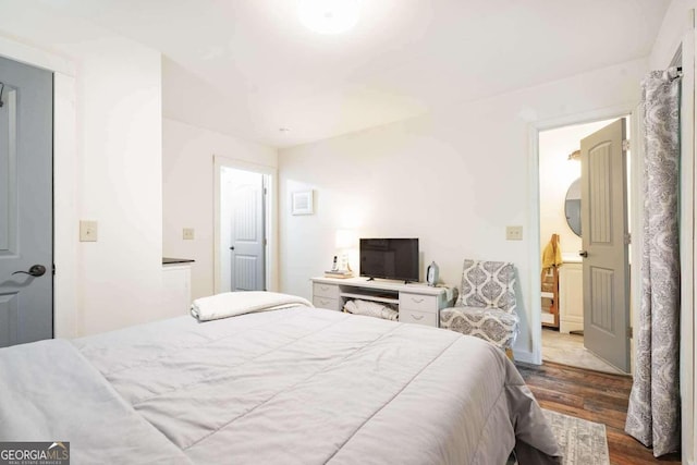 bedroom with dark wood-type flooring