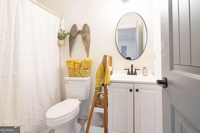 bathroom featuring toilet, a shower with curtain, and vanity