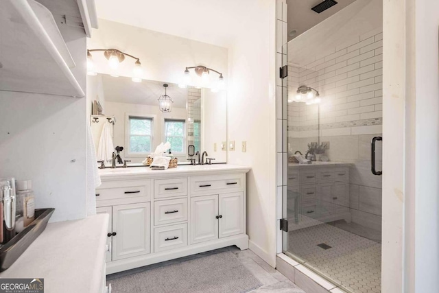 bathroom featuring a shower with door, vanity, and tile patterned flooring