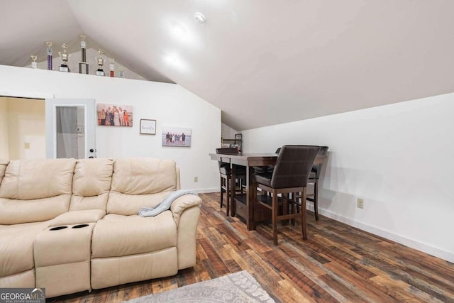 living room featuring vaulted ceiling and dark hardwood / wood-style flooring