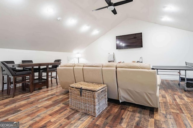 living room featuring ceiling fan, dark wood-type flooring, and vaulted ceiling