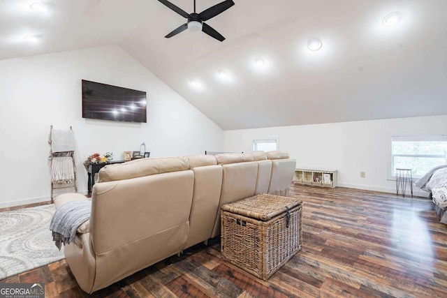 cinema room with ceiling fan, lofted ceiling, and dark hardwood / wood-style floors