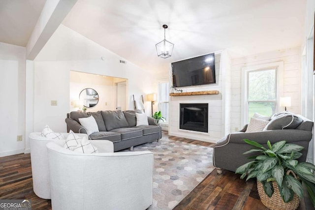 living room featuring a notable chandelier, lofted ceiling, and dark hardwood / wood-style floors