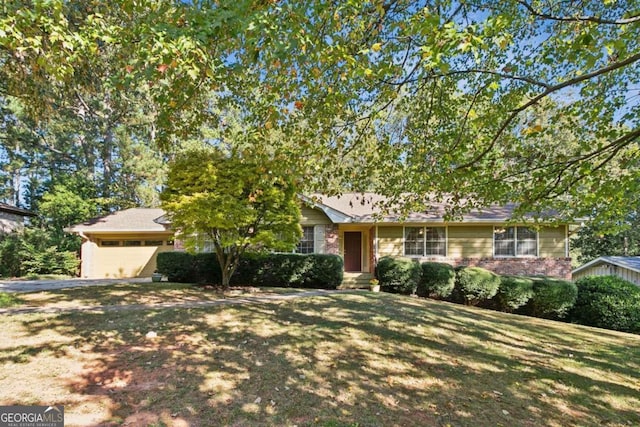 view of front of house with a front yard and a garage