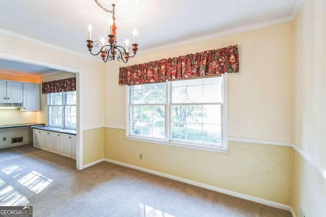 unfurnished dining area featuring ornamental molding, a chandelier, carpet flooring, and plenty of natural light