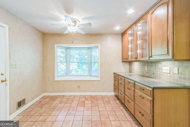 kitchen featuring tasteful backsplash, light tile patterned floors, and ceiling fan