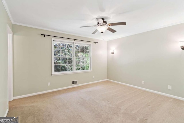 empty room with ceiling fan, ornamental molding, and light colored carpet