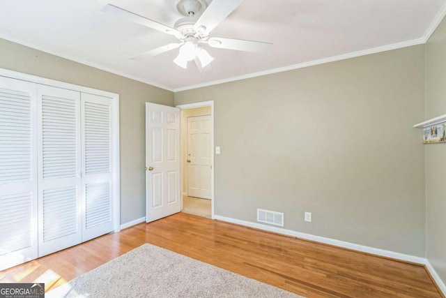 unfurnished bedroom featuring ornamental molding, hardwood / wood-style flooring, and ceiling fan