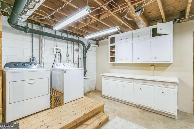 washroom featuring cabinets and independent washer and dryer