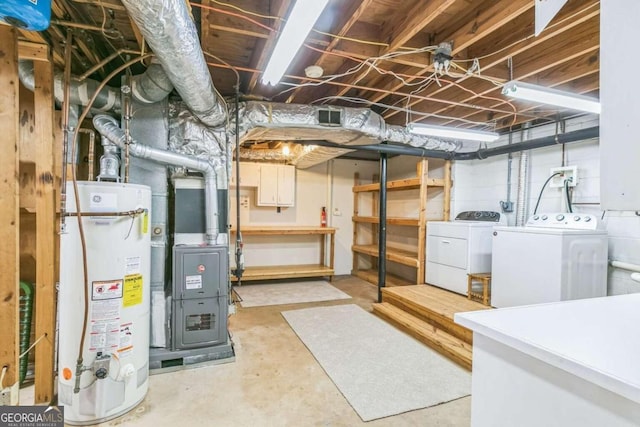 basement featuring independent washer and dryer, heating unit, and water heater