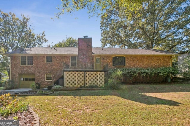 back of house with a lawn and a garage