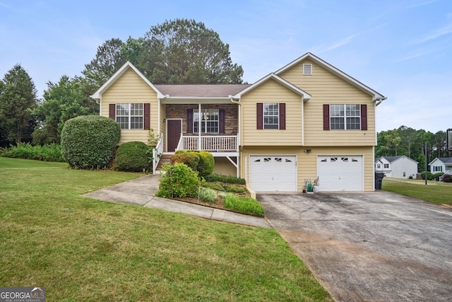 view of front of house featuring a porch, a front lawn, and a garage