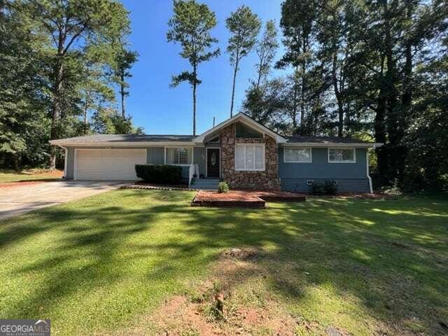 single story home with a front lawn and a garage