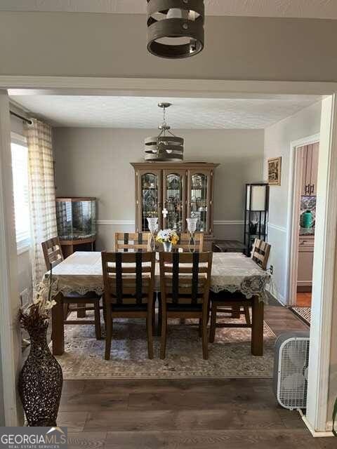 dining room with an inviting chandelier and dark hardwood / wood-style floors