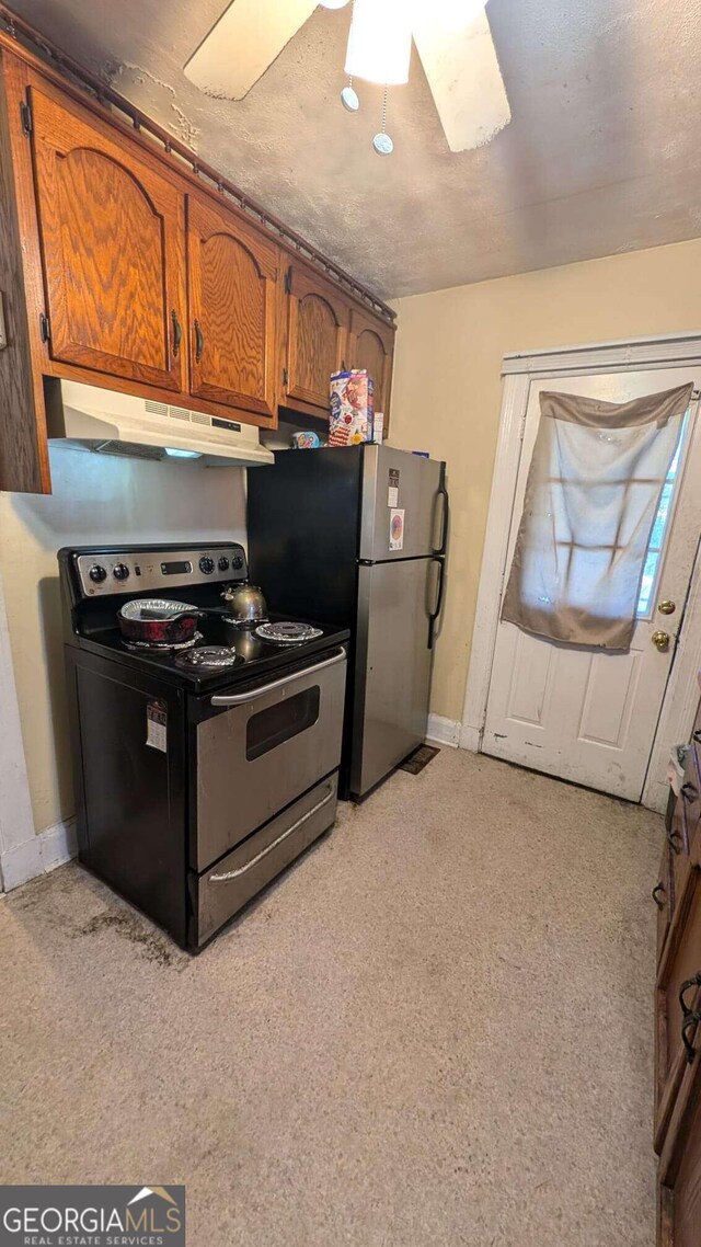 kitchen with stainless steel fridge, light colored carpet, electric range, and ceiling fan