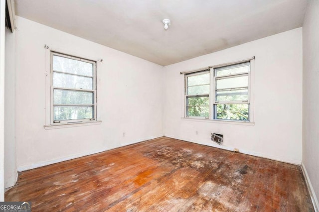 empty room with dark hardwood / wood-style flooring