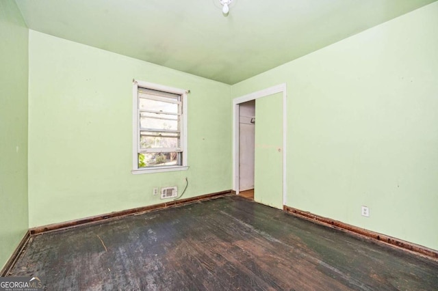 unfurnished room with dark hardwood / wood-style floors