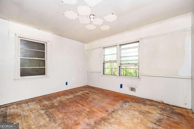 spare room featuring wood-type flooring