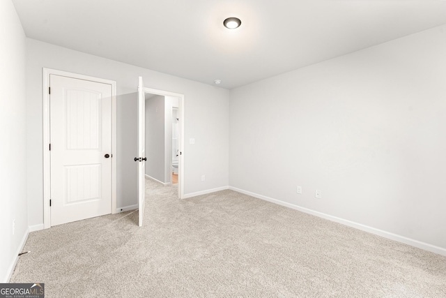 unfurnished room featuring light colored carpet