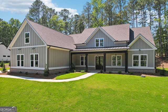 view of front of property with covered porch and a front lawn