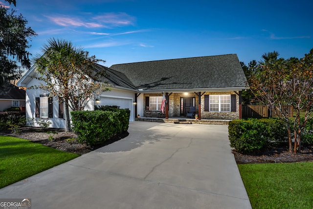 view of front of property featuring a front lawn and a garage