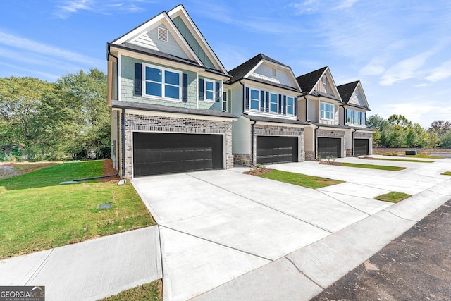 view of front of property with a front yard and a garage