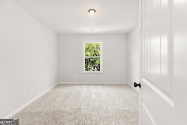 empty room featuring light carpet