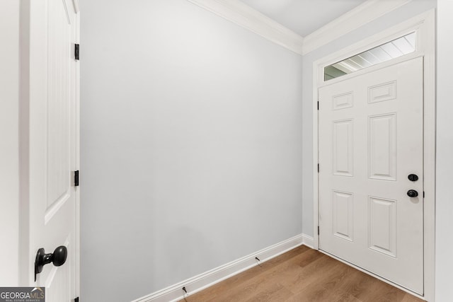 entryway with light hardwood / wood-style floors and ornamental molding