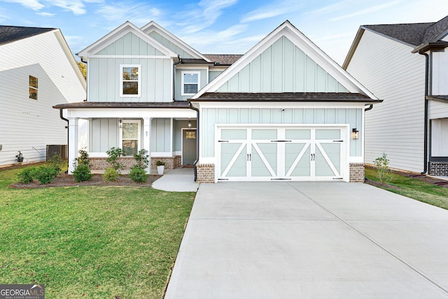 view of front of home featuring a front yard, a garage, and a porch