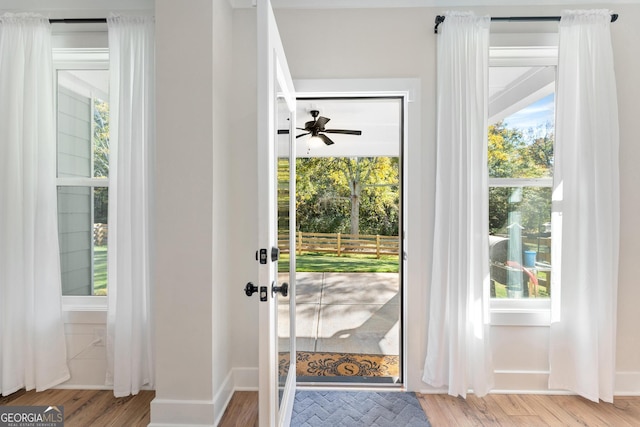 doorway featuring light hardwood / wood-style floors and ceiling fan