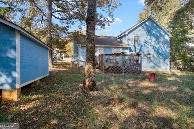 back of house featuring a wooden deck