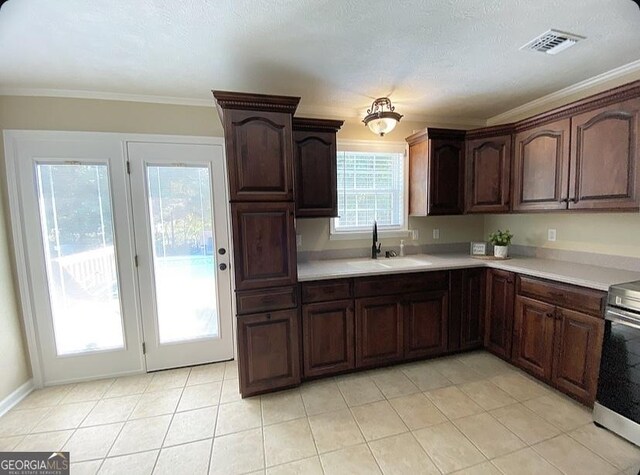 108 Sunset Dr, Dublin, GA 31027 - kitchen featuring a sink, visible vents, light countertops, ornamental molding, and electric range