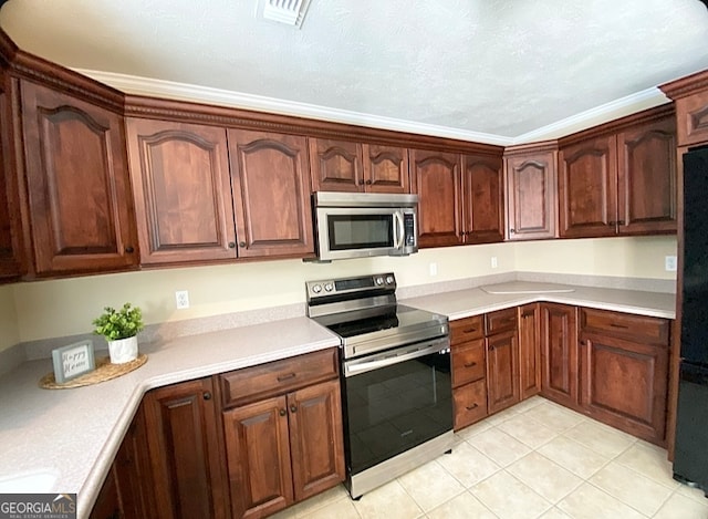 kitchen featuring appliances with stainless steel finishes, crown molding, a textured ceiling, and light tile patterned floors