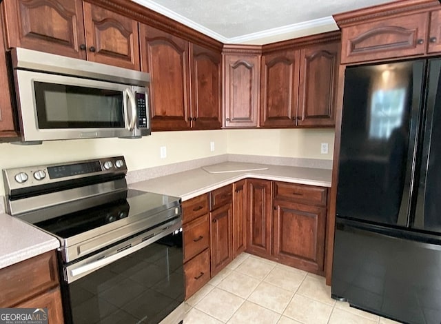 kitchen featuring crown molding, stainless steel appliances, a textured ceiling, and light tile patterned floors