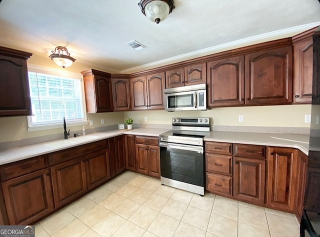 kitchen with sink, stainless steel appliances, and a textured ceiling