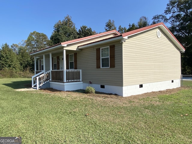 108 Sunset Dr, Dublin, GA 31027 - view of front of home with a porch, a front yard, metal roof, and crawl space