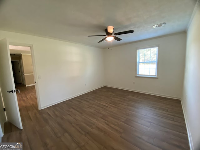 unfurnished room featuring dark wood-type flooring, crown molding, and ceiling fan