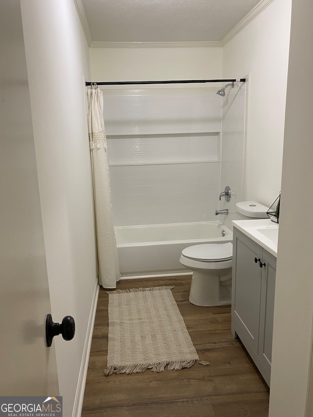 full bathroom with shower / tub combo, hardwood / wood-style flooring, toilet, ornamental molding, and vanity