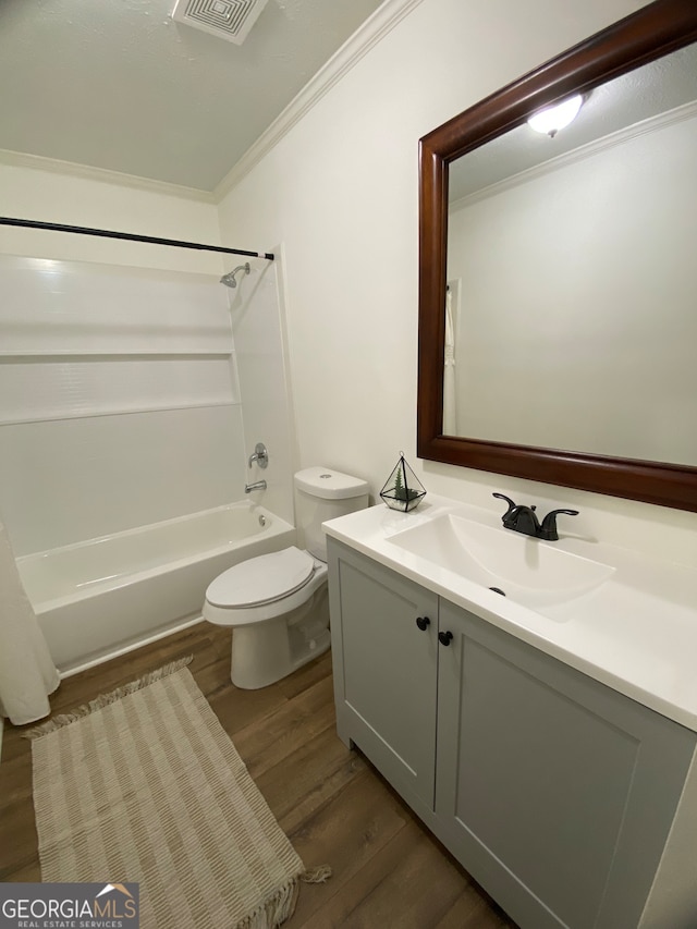 full bathroom with toilet, shower / washtub combination, hardwood / wood-style floors, crown molding, and vanity