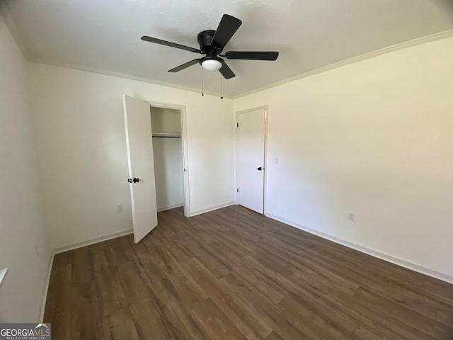 unfurnished bedroom featuring ornamental molding, dark hardwood / wood-style floors, and ceiling fan