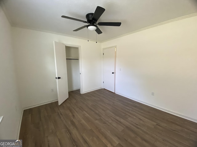 108 Sunset Dr, Dublin, GA 31027 - unfurnished bedroom with crown molding, ceiling fan, baseboards, a closet, and dark wood-style flooring