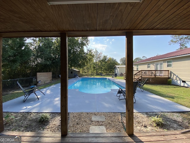 108 Sunset Dr, Dublin, GA 31027 - view of swimming pool featuring a patio, a storage unit, a wooden deck, and an outbuilding