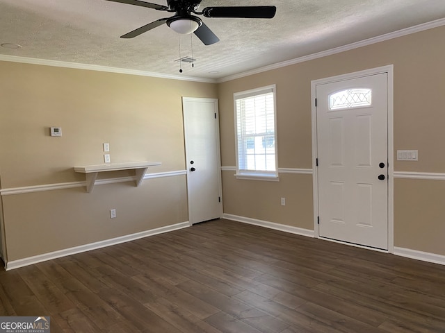 foyer featuring ornamental molding, dark wood-type flooring, a textured ceiling, and ceiling fan