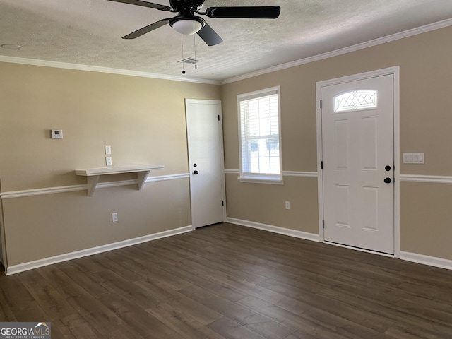 108 Sunset Dr, Dublin, GA 31027 - foyer with dark wood finished floors, ornamental molding, ceiling fan, baseboards, and a textured ceiling