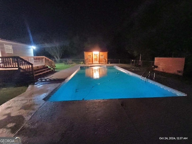 pool at night with a deck