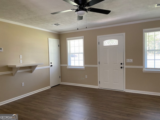 entryway featuring ornamental molding, dark wood-type flooring, a healthy amount of sunlight, and ceiling fan