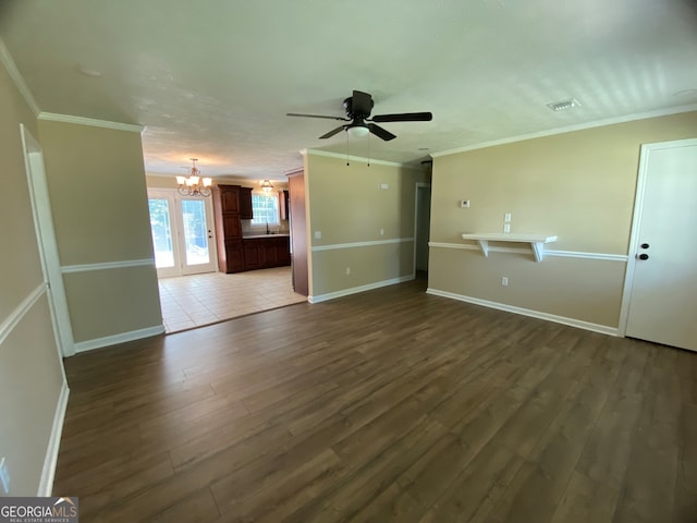 unfurnished room featuring crown molding, ceiling fan with notable chandelier, and dark hardwood / wood-style flooring