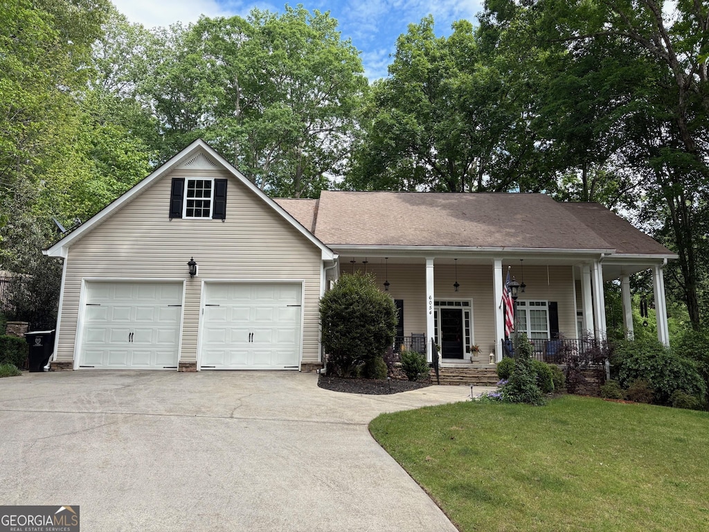 6054 Nebo Rd, Hiram, GA 30141 - view of front of home featuring covered porch, concrete driveway, an attached garage, and a front lawn