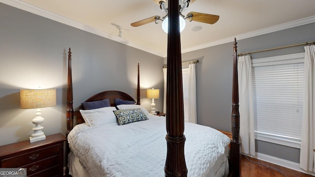 bedroom with dark wood-style floors, baseboards, ornamental molding, and a ceiling fan