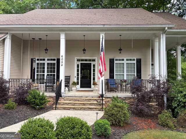 6054 Nebo Rd, Hiram, GA 30141 - view of exterior entry featuring a porch and roof with shingles